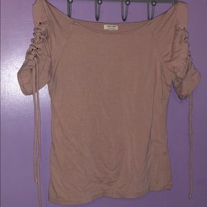 Blush pink, adjustable strings on arms.